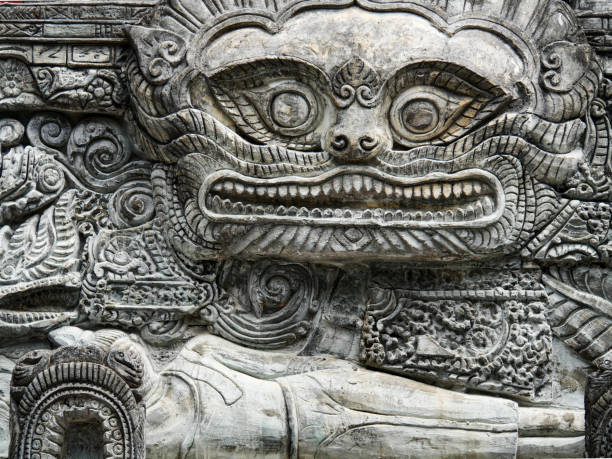 Stone carving of a face with open mouth