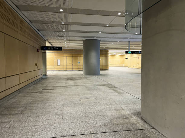 istock A sleek and modern underground metro station featuring sandstone walls, concrete columns, and polished floors 2195392044