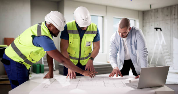 istock Diverse group of professionals inspecting house interior during construction 2195392115