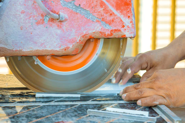 istock Hands operate a cutting tool to shape tiles in a workshop during daylight hours 2195393940