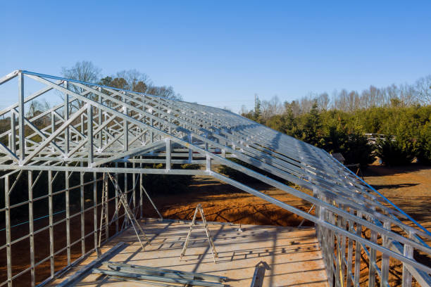 istock Construction of a metal framework for a large industrial building on a clear, sunny day in a rural area 2195393963