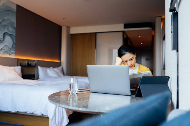 istock Asian businesswoman with laptop and digital tablet, preparing for a constructive discussion at the business convention. 2195395898