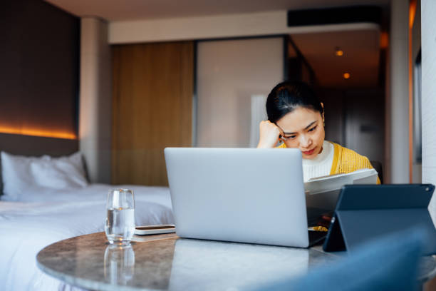 istock Asian businesswoman with laptop and digital tablet, preparing for a constructive discussion at the business convention. 2195395900