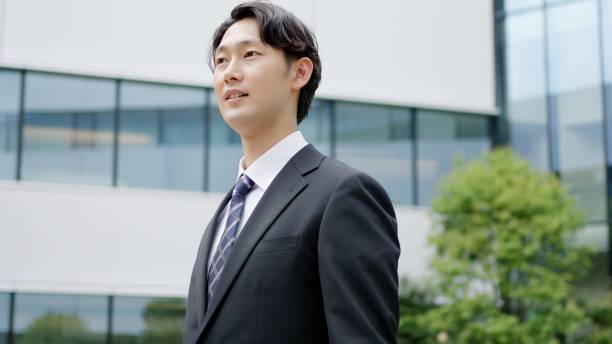 istock Businessman walking in an office district 2195396724