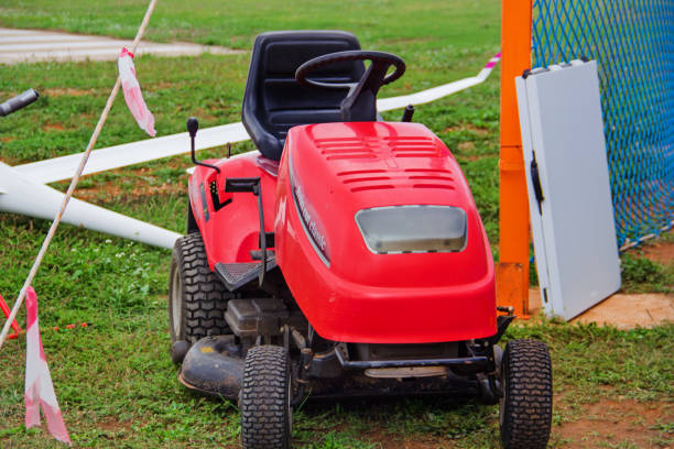 A special tractor with a mower for mowing grass on the side of the road against the background of a forest, industry. Copy space for text, job