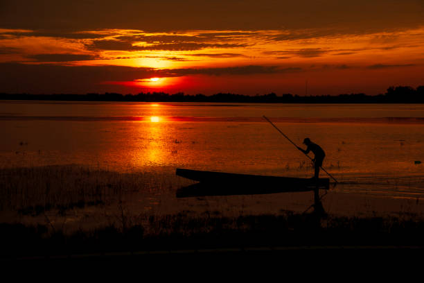 istock Scenic view dramatic beautiful sunset sky. Natural Sunset Sunrise on meadow silhouette shadow dark land. Vibrant dramatic sky on sunset, dawn, sunrise in Countryside. Landscape Colorful Sky At Sunset 2195398524