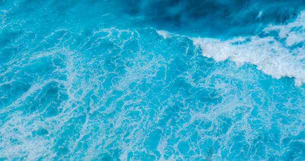 istock Turquoise ocean sea water white wave pattern splashing deep blue sea. Seascape dark ocean background wave splash on rock. Tropical sea beach in summer seaside outdoor. Water Surface blue wave pattern 2195398705