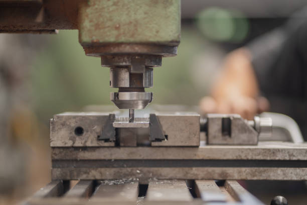 istock Man drills metal with milling machine 2195400222