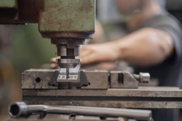 istock Man drills metal with milling machine 2195400235