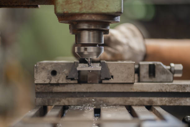 istock Man drills metal with milling machine 2195400319