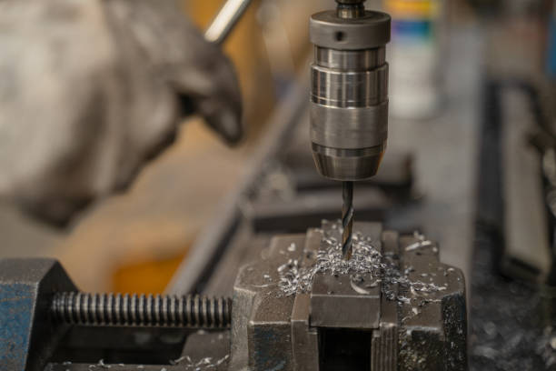istock Man drills metal with milling machine 2195401292