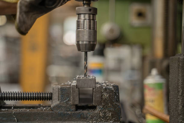istock Man drills metal with milling machine 2195401294