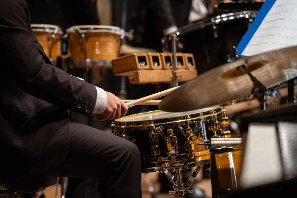 istock Drummer plays cymbals in orchestra 2195401338