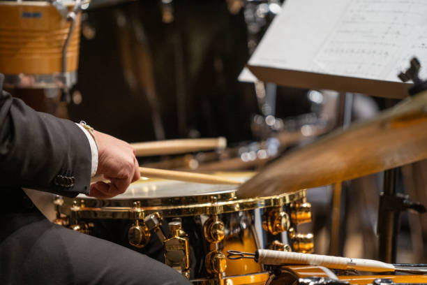 istock Drummer plays cymbals in orchestra 2195401342