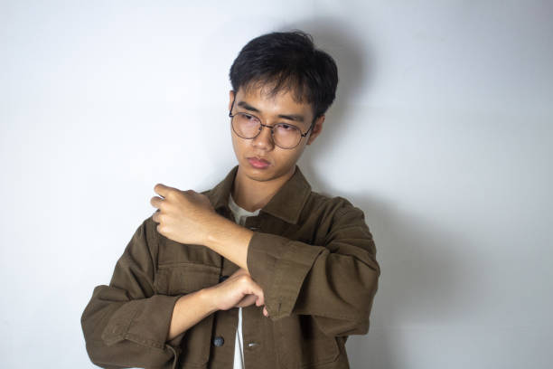 teenager in brown jacket is folding his jacket sleeves