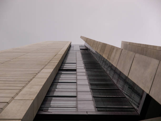 A view from below of  a modern building with glasses windows and concrete in Kuala Lumpur.