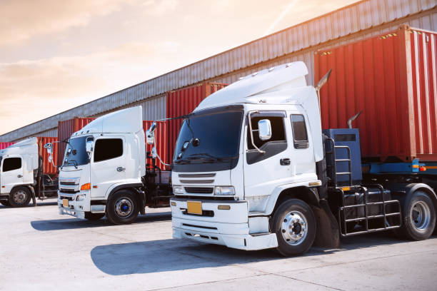 istock Semi Trailer Trucks on The Parking Lot at Warehouse. Trucks Loading Goods at Dock Warehouse. Distribution Warehouse Center. Containers Shipping. Freight Truck Logistics, Cargo Transportation. 2195406369