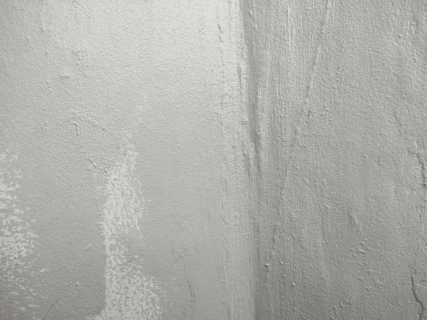 istock Close-up of textured gray wall with uneven paint and rough surface. 2195406933