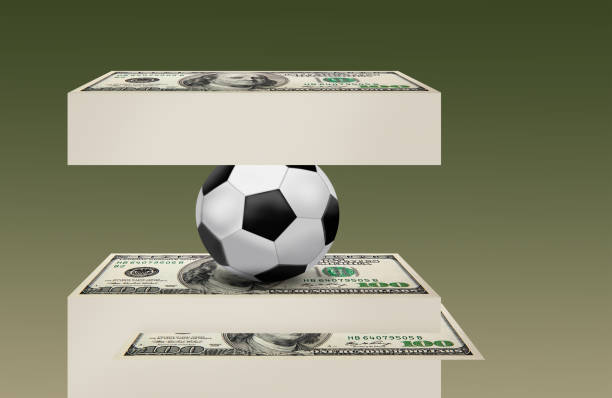 istock A stack of 100 dollars under a soccer ball 2195410890