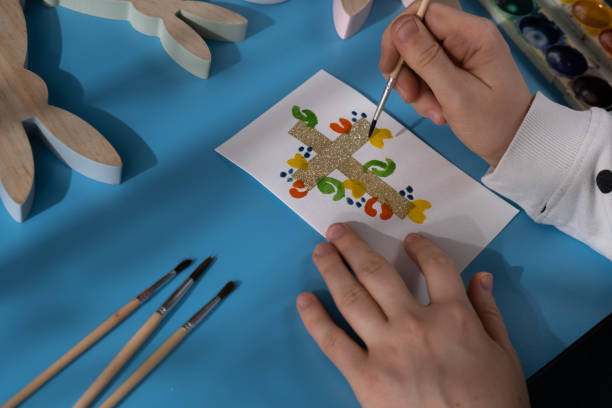 istock Painting Easter cross Gift Easter idea. Do it yourself instruction postcard eco-friendly decoration. Making handmade art presents children's diy projects. Spring holiday family time 2195412170