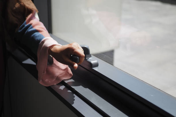 istock hand open gray plastic pvc window at home at early morning 2195412814