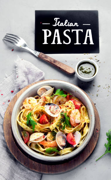istock Pasta with seafood on gray background. 2195412825