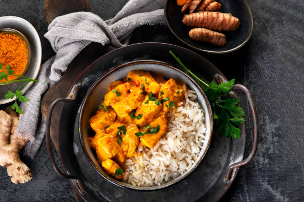 istock Indian butter chicken curry with basmati rice on dark background. 2195412868