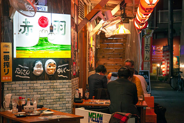Group of people talking and eating in traditional Japanese restaurant
