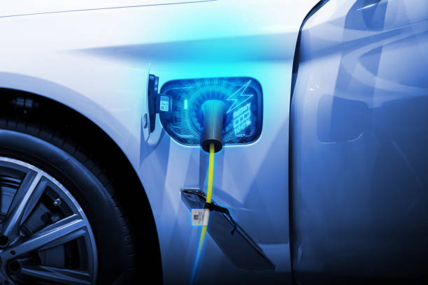 istock Power cable pump plug in charging power to electric vehicle EV car. 2195414584
