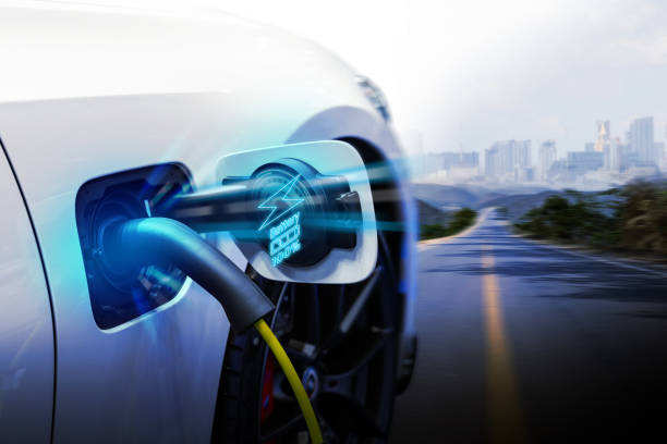 istock Power cable pump plug in charging power to electric vehicle EV car. 2195414603
