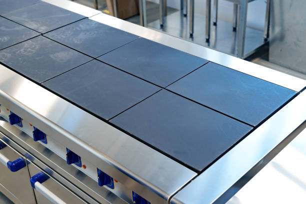 istock Professional kitchen cooking station with stainless steel surface and ceramic cooktop designed for culinary efficiency 2195415034