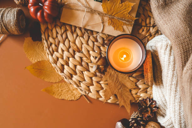 istock Burning candle in a cozy warm homey autumn atmosphere 2195415172