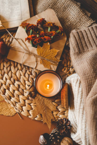 istock Burning candle in a cozy warm homey autumn atmosphere 2195415176