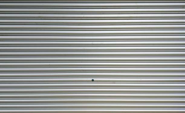 istock striped metal shutter sliding door texture background 2195415183