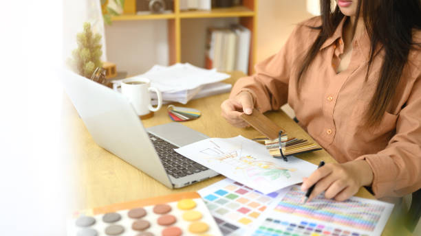 istock Interior designer working on color palettes and design sketches at desk 2195415201