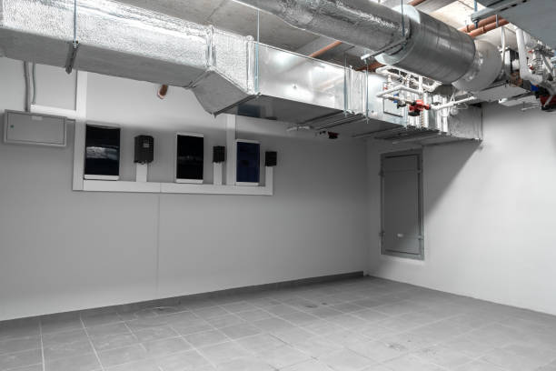 Industrial basement room with ventilation system and empty floor space in an urban setting