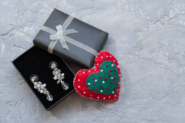 Earring in gift box with ribbon