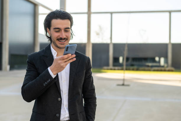 istock Person Sending a Voice Message.Authentic Corporate Professional Using Smartphone to Manage Emails or Online Communication,Perfect for Illustrating Modern Work,Business Success and Digital Connectivity 2195416344