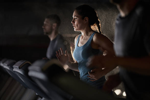 istock Athletic woman jogging on treadmill in a gym. 2195419686