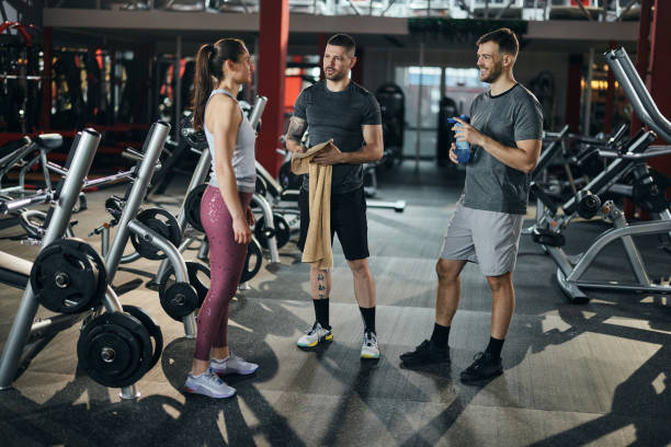 istock Happy athletes communicating while having a break in a gym. 2195419845