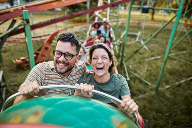 istock Young happy couple having fun on rollercoaster at amusement park. 2195420023