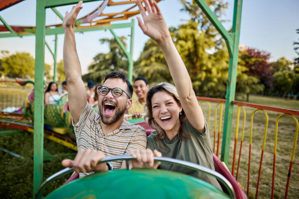 istock Young carefree couple having fun on rollercoaster ride at amusement park. 2195420364