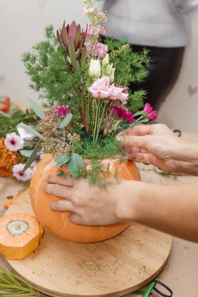 istock Creating a floral composition in a pumpkin. Making decor with your own hands. 2195420509