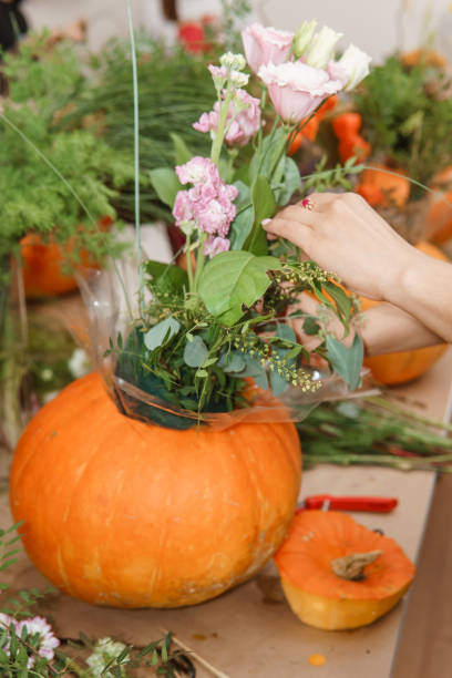 istock Creating a floral composition in a pumpkin. Making decor with your own hands. 2195420517
