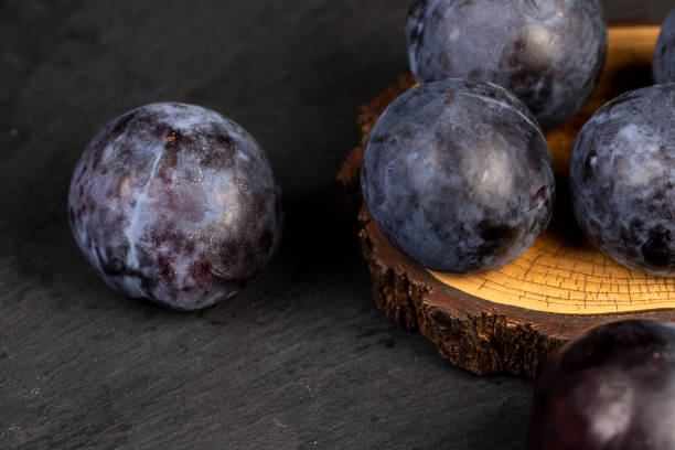 istock ripe purple plum on the table 2195421744