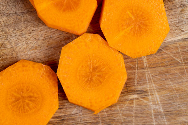 sliced orange carrots on the table during cooking, sweet ripe orange carrots peeled and washed for cooking