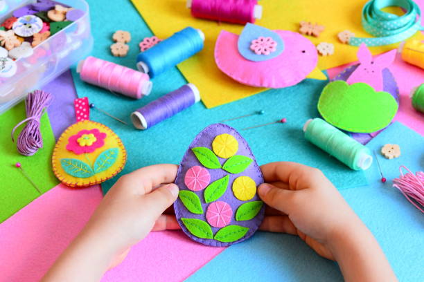 istock A small child holds a felt Easter egg decor in his hands. Holiday spring crafts DIY concept 2195424037