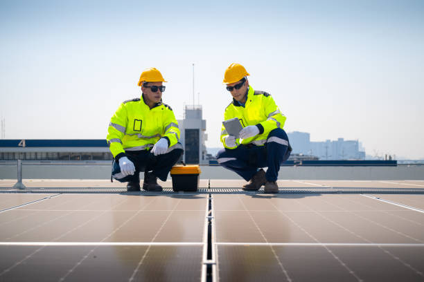 istock The technician is inspecting solar panels on a factory roof. 2195425259