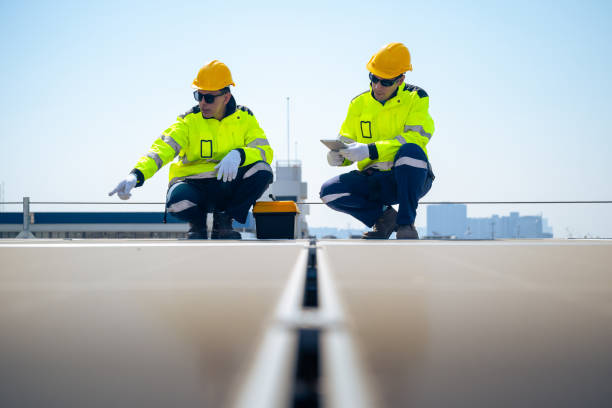 istock The technician is inspecting solar panels on a factory roof. 2195425265