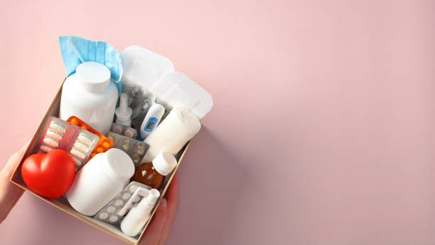 istock First aid kit with various medical supplies on a pink background 2195425318